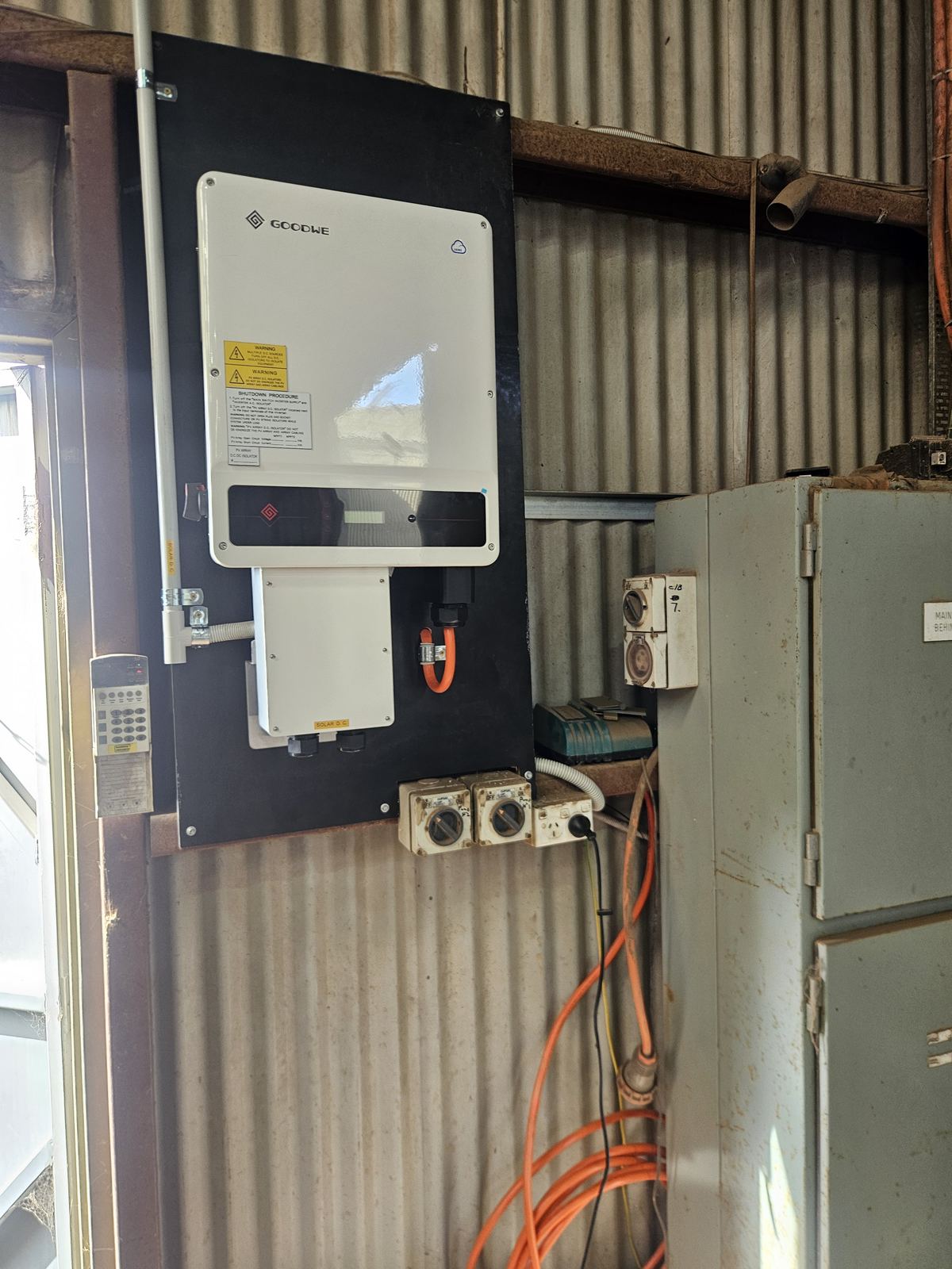 Solar inverter installation on a shed wall, North Suburbs