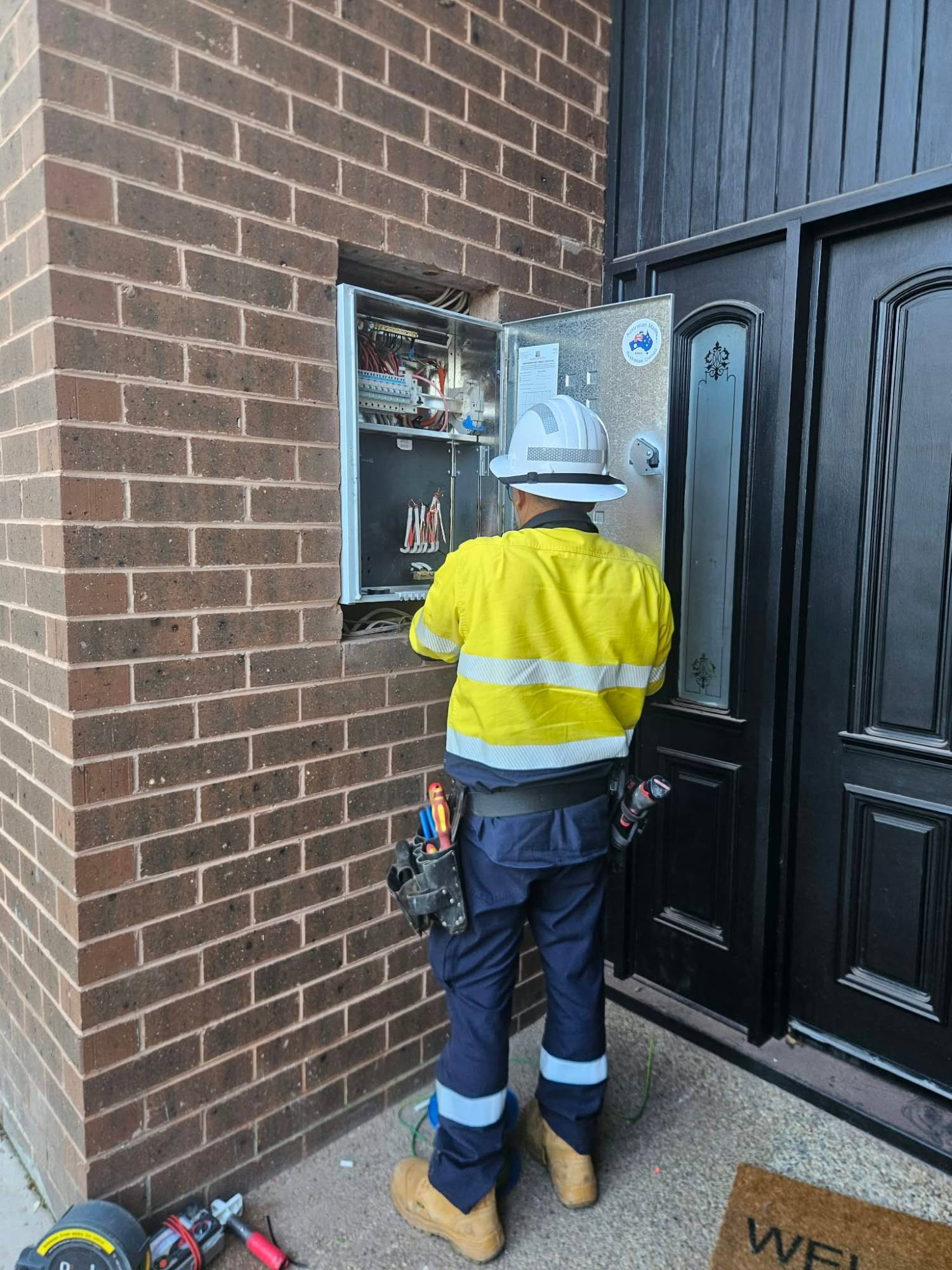 Electrician servicing a switchboard and meter box, East Suburbs